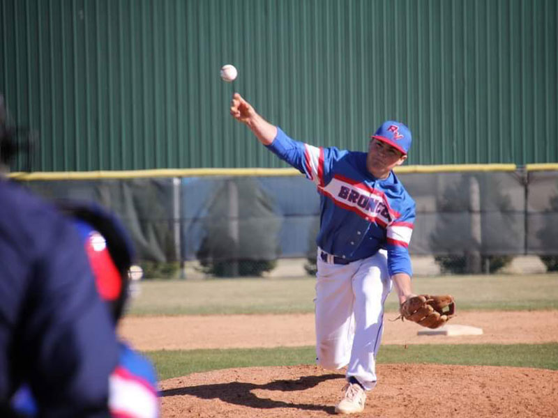 Russell/Victoria's Kaden Rome pitching in Colby on Thursday, April 1. (Photo courtesy Chris Roth)