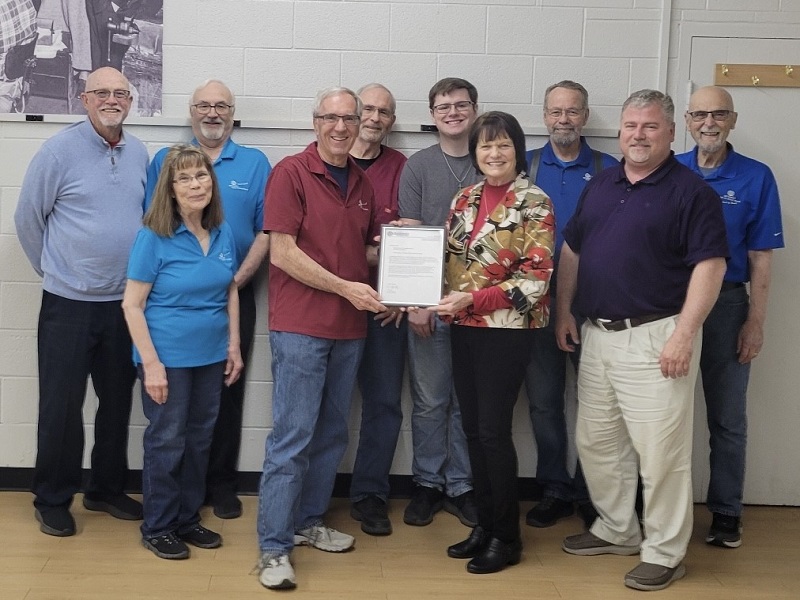 Kansas District Optimist Governor Judy Morris presenting a letter from Optimist International President Tracy Huxley recognizing the Club's 75th Anniversary.