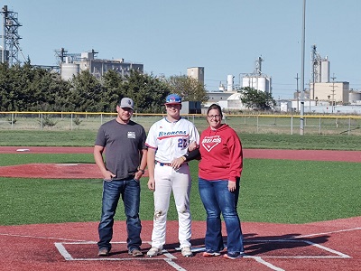 Russell-Victoria Baseball Player Will Scherrer stands at home plate with his parents during the Senior Day ceremony held in between games of the Broncos' doubleheader with Southeast of Saline at the Shaffer Sports Complex on Thursday, May 2, 2024.